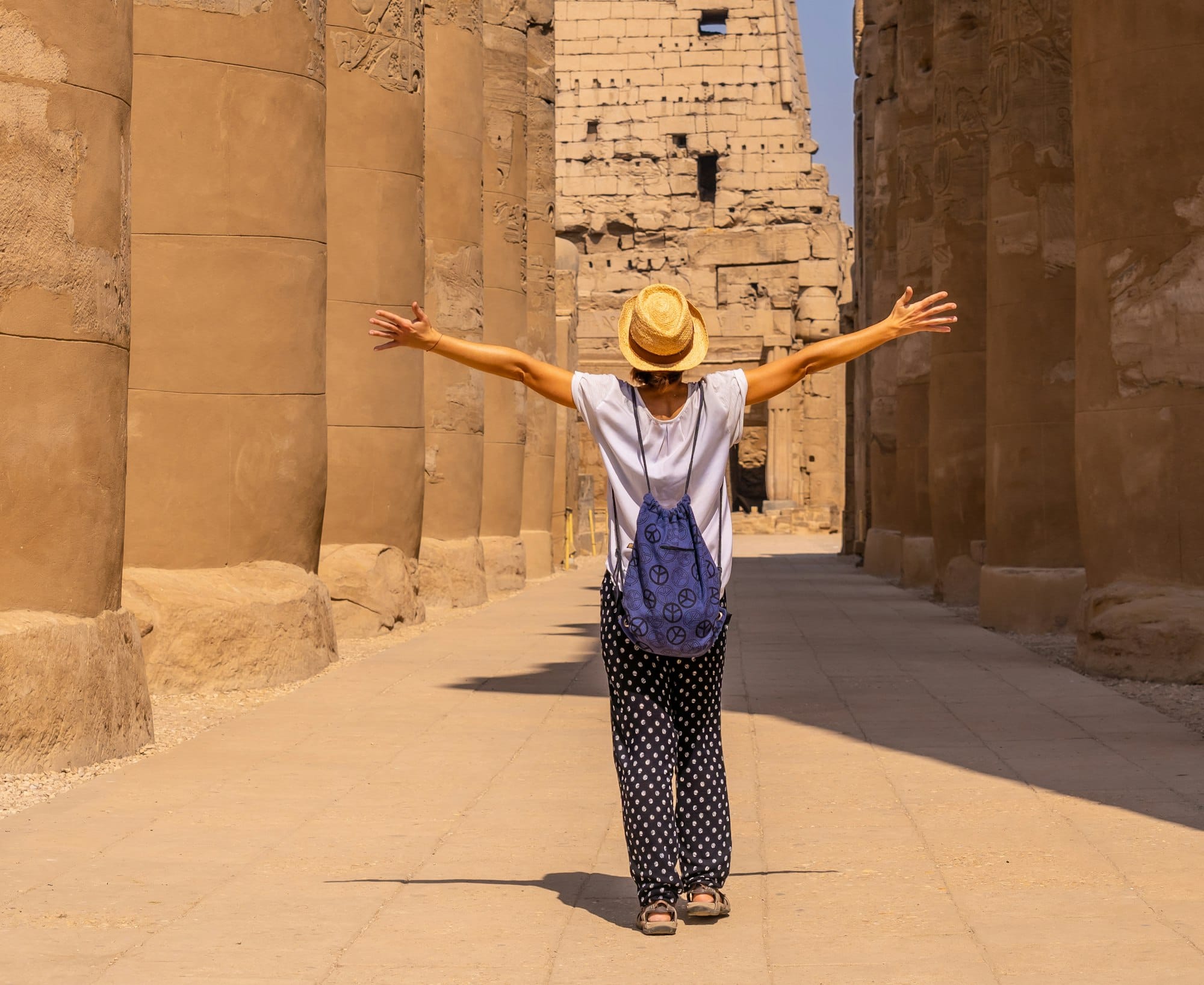 Woman tourist wearing a hat visiting the Egyptian Temple of Luxor. Egypt