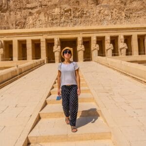 A young woman on the entrance stairs to the Funerary Temple of Hatshepsut in Luxor