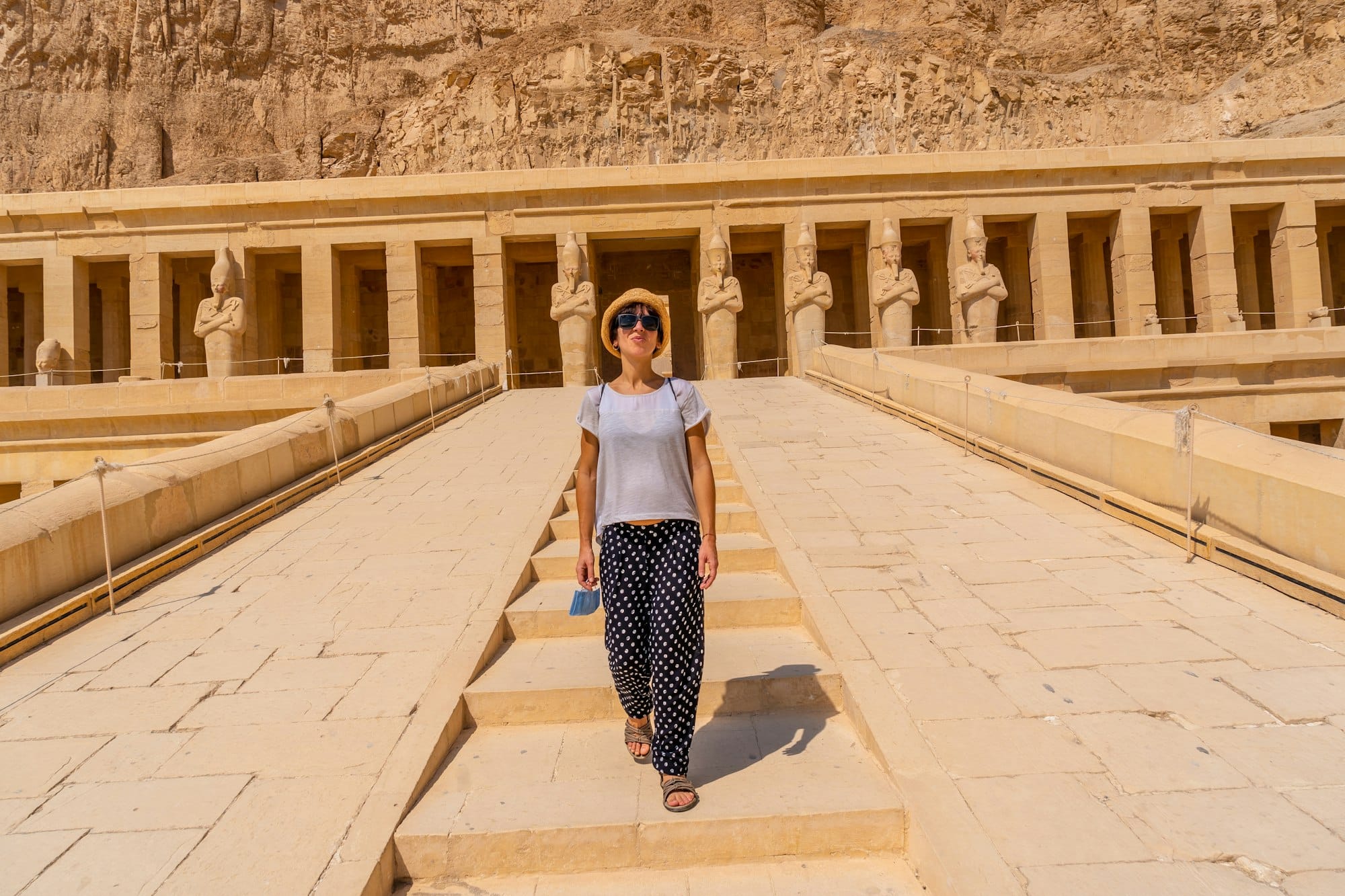 A young woman on the entrance stairs to the Funerary Temple of Hatshepsut in Luxor