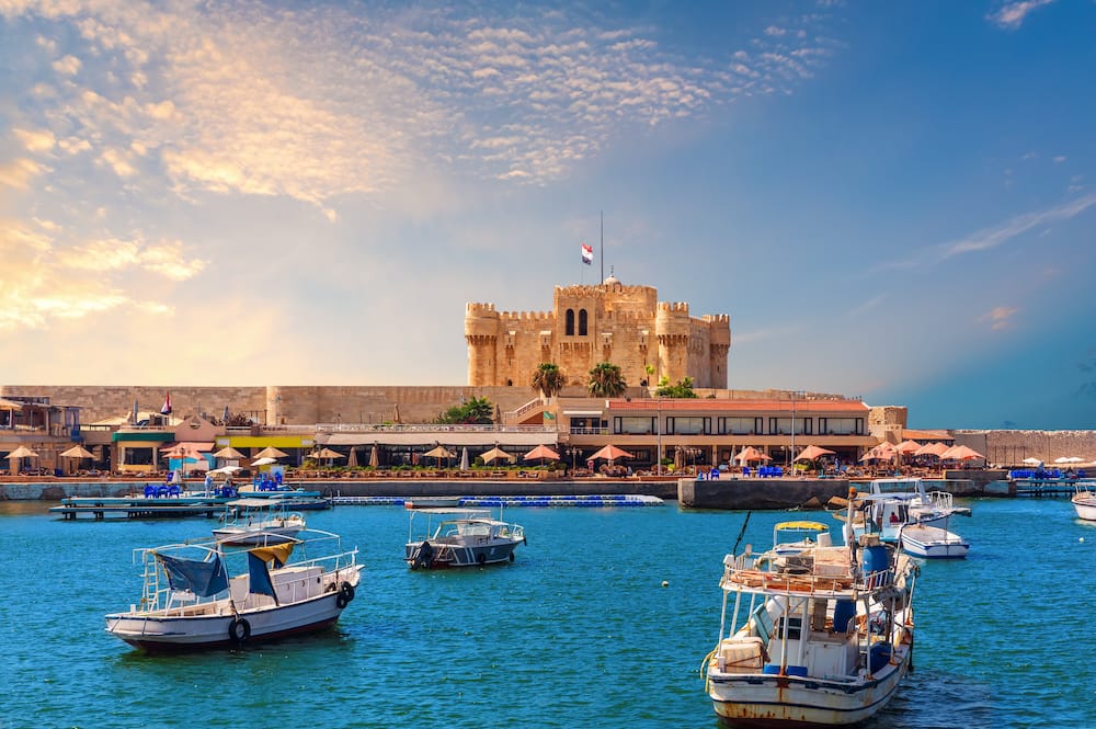 Boats in the harbour near famous Citadel of Qaitbay, Alexandria, Egypt.