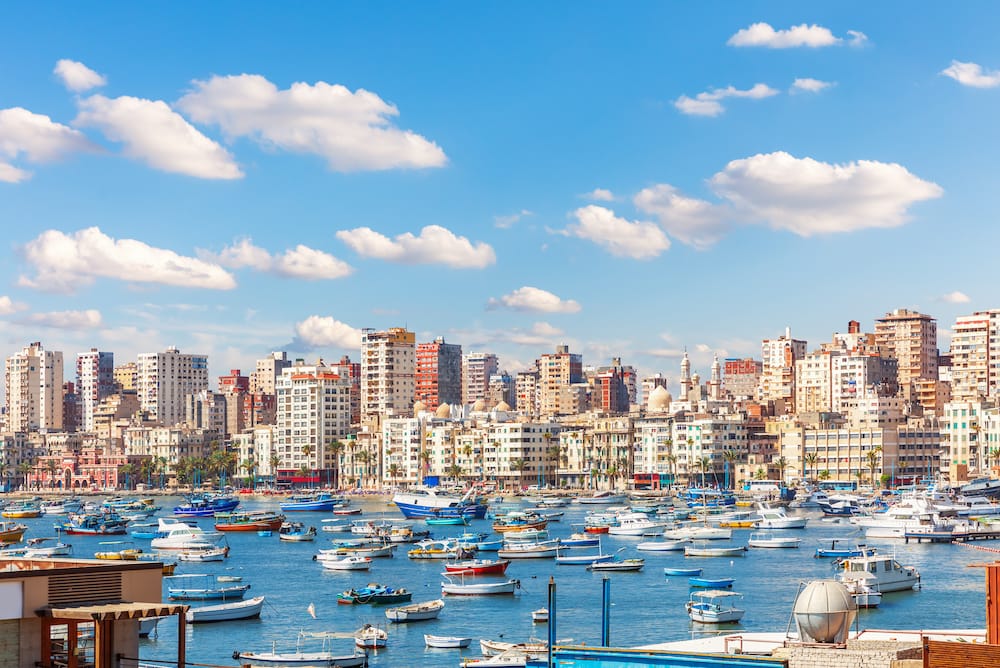 Boats near the pier and view of Alexandria coast, Egypt.